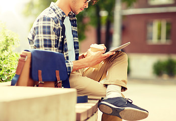 Image showing man with tablet pc and coffee on city street bench