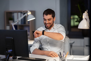 Image showing businessman using voice command on smart watch