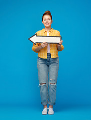 Image showing red haired teenage girl with arrow showing to left