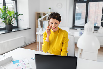 Image showing happy ui designer calling on smartphone at office