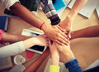 Image showing group of international students with hands on top