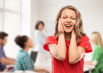 Image showing annoyed teenage girl covering her ears with hands