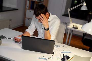 Image showing businessman with papers working at night office