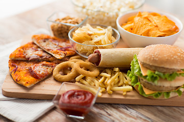 Image showing close up of fast food on wooden board