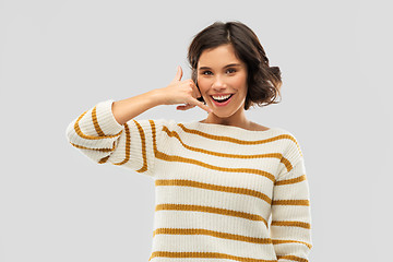 Image showing happy smiling woman showing phone call gesture