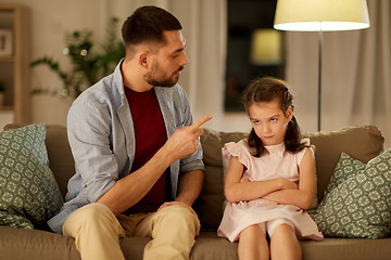 Image showing upset or feeling guilty girl and father at home