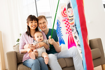 Image showing mixed-race family with koinobori carp streamer