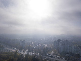 Image showing Sunny foggy morning sky above residential areas.