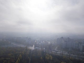 Image showing Cityscape with houses on a sunny foggy sky background.