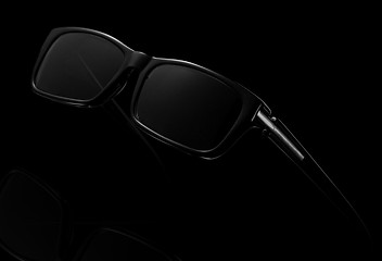 Image showing Black sunglasses on a dark background.