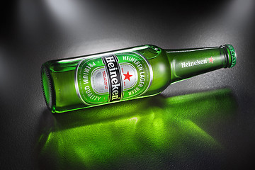 Image showing UKRAINE, KYIV - APRIL 02, 2014. Bottle of Heineken Lager Beer with reflection. Heineken is the flagship product of Heineken International