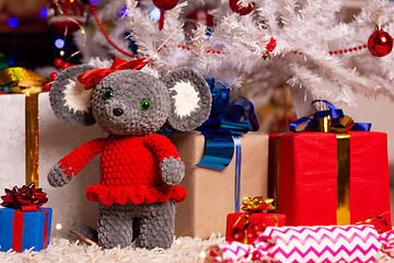 Image showing Plush mouse together with gifts under the Christmas tree