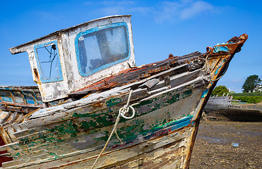 Image showing Old wooden boat hull with decayed wood, peeling paint