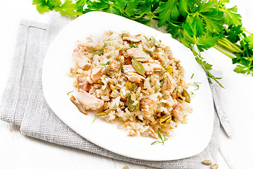 Image showing Salad of salmon and rice in plate on light board