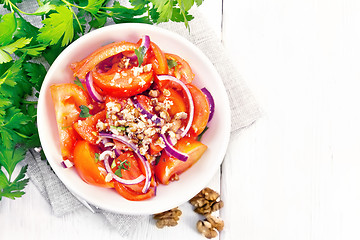 Image showing Salad with tomato and walnut in plate on board top