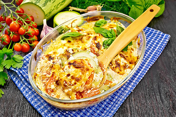 Image showing Zucchini baked with tomatoes in glass pan on board