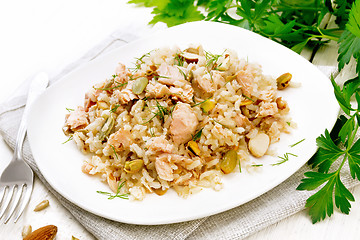 Image showing Salad of salmon and rice in plate on white board