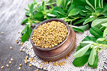 Image showing Fenugreek in bowl with leaves on wooden board