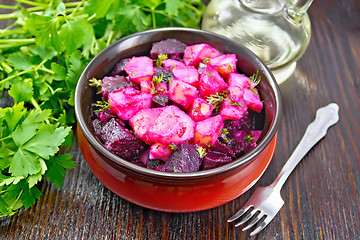 Image showing Salad of beets and potatoes with oil in bowl on table