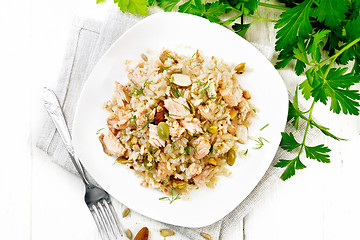 Image showing Salad of salmon and rice in plate on board top