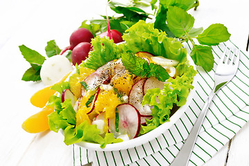 Image showing Salad of radish and orange with mint on table