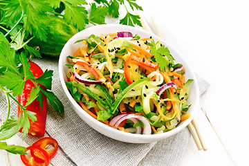 Image showing Salad of cucumber in bowl on wooden board