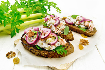 Image showing Bruschetta with fish and curd on light wooden board