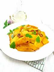 Image showing Pumpkin with garlic and mint in plate on white board