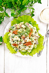 Image showing Salad of salmon and avocado with mayonnaise on light board top