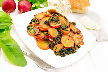 Image showing Radish with spinach and spices in plate on board