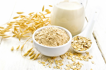 Image showing Flour oat in bowl with milk on white board