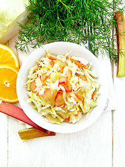 Image showing Salad of cabbage and rhubarb in plate on light board top