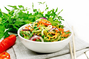 Image showing Salad of cucumber in bowl on board