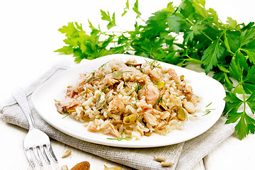 Image showing Salad of salmon and rice in plate on board