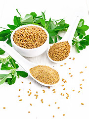 Image showing Fenugreek in two spoons and bowl with leaves on white board