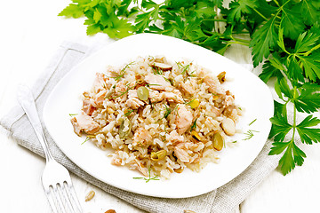 Image showing Salad of salmon and rice in plate on wooden board