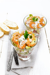 Image showing Salad with shrimp and avocado in two glasses on board