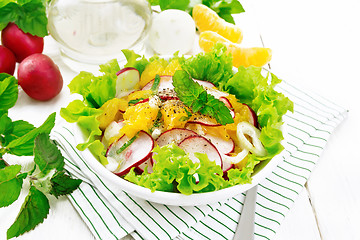 Image showing Salad of radish and orange with mint on light board