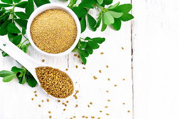 Image showing Fenugreek in spoon and bowl with leaves on board top