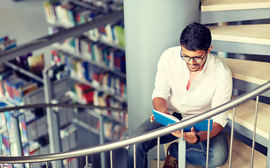 Image showing hindu student boy or man reading book at library