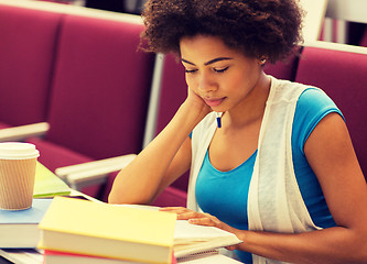 Image showing student girl with books and coffee on lecture