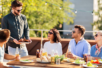 Image showing friends at bbq party on rooftop in summer