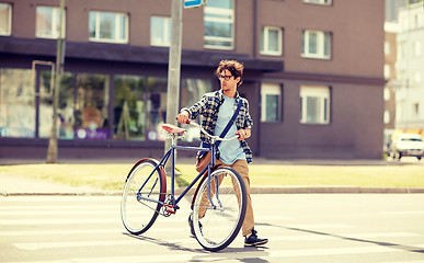 Image showing young man with fixed gear bicycle on crosswalk