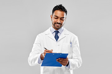 Image showing smiling indian doctor or scientist with clipboard