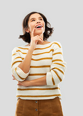 Image showing happy woman in striped pullover looking up