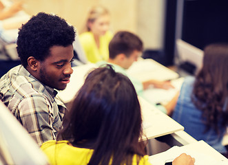 Image showing group of students talking in lecture hall