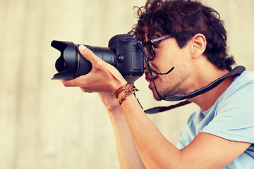 Image showing close up of photographer with camera shooting