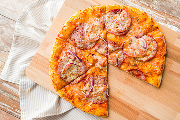 Image showing close up of homemade pizza on wooden table