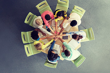 Image showing group of international students with hands on top