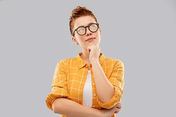 Image showing thinking redhead teenage student girl in glasses